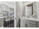 Elegant powder room featuring modern fixtures, a white marble countertop, and contemporary vanity at 6442 Canopy Dr, Sandy Springs, GA 30328