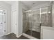 Bathroom featuring a modern shower with glass doors and tiled walls and floor at 6442 Canopy Dr, Sandy Springs, GA 30328