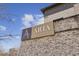 Exterior shot of the community signage, displaying the name 'Aria Village' on a brick building at 6442 Canopy Dr, Sandy Springs, GA 30328