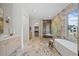 Luxurious bathroom with marble accents, a soaking tub, and a glass shower at 0 Chattahoochee St, Roswell, GA 30075