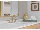 Bathroom vanity with marble countertop, gold fixtures, and decorative accents enhances its elegance at 0 Chattahoochee St, Roswell, GA 30075
