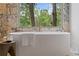Freestanding tub with marble surround and large windows offers a spa-like experience at 0 Chattahoochee St, Roswell, GA 30075