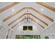 Exposed wood beams and contemporary lighting accent the vaulted ceiling design at 0 Chattahoochee St, Roswell, GA 30075
