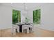 An elegant dining room with large windows offering a view of the surrounding greenery at 0 Chattahoochee St, Roswell, GA 30075