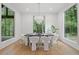 Bright dining room features large windows, modern lighting, and beautiful wooded views at 0 Chattahoochee St, Roswell, GA 30075