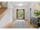 Inviting foyer with hardwood floors, staircase, statement lighting, and sliding glass doors that offer a view of the yard at 0 Chattahoochee St, Roswell, GA 30075