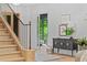 Inviting foyer features wooden stairs, decorative accents, and hardwood flooring at 0 Chattahoochee St, Roswell, GA 30075