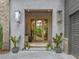 Inviting front entry with glass front door, gas lanterns and neutral stucco at 0 Chattahoochee St, Roswell, GA 30075