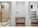 Stylish hallway featuring a built-in desk area, leading to a glass-enclosed shower and a closet with shelving at 0 Chattahoochee St, Roswell, GA 30075