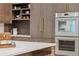 A modern kitchen with marble countertops and built-in stainless steel appliances at 0 Chattahoochee St, Roswell, GA 30075