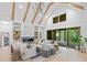 Spacious living room with vaulted ceiling, modern fireplace, and access to outdoor space at 0 Chattahoochee St, Roswell, GA 30075
