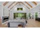 Bright living room with vaulted ceiling, wood beams, fireplace, and access to outdoor space at 0 Chattahoochee St, Roswell, GA 30075