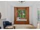 Light-filled loft space with window seat, built-in shelving, and views of the outdoors at 0 Chattahoochee St, Roswell, GA 30075