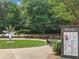Inviting outdoor seating area with tables and chairs, surrounded by lush greenery and a modern flower sculpture at 0 Chattahoochee St, Roswell, GA 30075