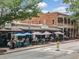 Street view of a commercial building with outdoor seating and lush trees at 0 Chattahoochee St, Roswell, GA 30075
