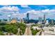 Stunning aerial view of city skyline with lush green trees and buildings at 325 E Paces Ferry Ne Rd # 1803, Atlanta, GA 30305