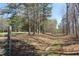 Scenic shot of the driveway with lush trees overhead leading to a private location, perfect for nature enthusiasts at 8740 Atlanta Newnan Rd, Chattahoochee Hills, GA 30268