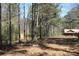 Landscaped property with trees and an exterior view of a cozy home, offering a blend of nature and comfort at 8740 Atlanta Newnan Rd, Chattahoochee Hills, GA 30268