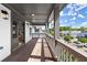 Cozy covered balcony with wood floors, gray railings and open door to the main bedroom at 1434 Fairmont Ave, Atlanta, GA 30318