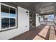 Picturesque covered balcony with wood floors, gray railings and view of neighborhood at 1434 Fairmont Ave, Atlanta, GA 30318