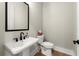 This half bathroom features a pedestal sink, a black faucet, and a toilet at 1434 Fairmont Ave, Atlanta, GA 30318