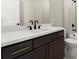 Modern bathroom vanity with dark wood cabinets and white countertop featuring stylish black fixtures at 1434 Fairmont Ave, Atlanta, GA 30318