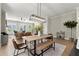 Bright dining space with wooden table set, integrated with an open living area and staircase at 1434 Fairmont Ave, Atlanta, GA 30318