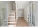 Elegant entryway with wood floors, staircase, and modern glass panel doors at 1434 Fairmont Ave, Atlanta, GA 30318