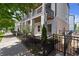 Townhome exterior featuring a fenced yard and double balconies with stylish columns at 1434 Fairmont Ave, Atlanta, GA 30318