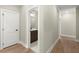 Hallway leading to a half bath, with wood floors and white trim at 1434 Fairmont Ave, Atlanta, GA 30318