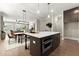 This open-concept kitchen features an island with seating, an oven, and modern lighting fixtures at 1434 Fairmont Ave, Atlanta, GA 30318