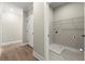 Well-lit laundry room area with washer hookups, wire shelves, and a tiled floor at 1434 Fairmont Ave, Atlanta, GA 30318