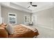Spacious main bedroom with tray ceilings, carpet floors, ceiling fan, and french doors to a balcony at 1434 Fairmont Ave, Atlanta, GA 30318