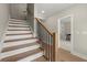 Elegant staircase with wood treads, white risers, and black metal balusters at 1434 Fairmont Ave, Atlanta, GA 30318