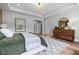 Well-lit bedroom showcasing a modern dresser and decor, blending comfort and style at 313 Brooke View Trl, Canton, GA 30115