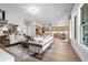 Bright and airy living room open to kitchen with modern furnishings and hardwood floors, ideal for entertaining at 313 Brooke View Trl, Canton, GA 30115