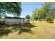 Spacious backyard with a well-maintained lawn, wooden deck, and privacy fence at 1045 Ridgecrest Se Dr, Smyrna, GA 30080
