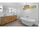 Bright bathroom features double vanity, soaking tub, modern lighting, and a large window at 1045 Ridgecrest Se Dr, Smyrna, GA 30080