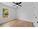 Bright bedroom with hardwood floors, ceiling fan and a view to the backyard at 1045 Ridgecrest Se Dr, Smyrna, GA 30080