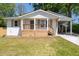 Charming renovated home featuring a wooden porch and convenient carport, perfect for modern living at 1045 Ridgecrest Se Dr, Smyrna, GA 30080
