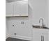 Laundry room with white cabinets, sink, and tile flooring at 1045 Ridgecrest Se Dr, Smyrna, GA 30080