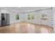 Bright living room with hardwood floors, stainless steel refrigerator, and natural light at 1045 Ridgecrest Se Dr, Smyrna, GA 30080