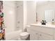 Bright bathroom featuring white tiled walls, a shower-tub combo, and a decorative floral shower curtain at 1976 Cobblestone Ne Cir, Atlanta, GA 30319