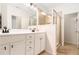Stylish bathroom features a double vanity, glass-enclosed shower, modern fixtures, and tile flooring at 1976 Cobblestone Ne Cir, Atlanta, GA 30319