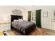 Charming bedroom featuring a black bed frame, unique metal wall decor, and vibrant green curtains at 1976 Cobblestone Ne Cir, Atlanta, GA 30319