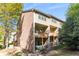 Multi-level exterior featuring a brick facade, wooden balconies, and a well-manicured lawn at 1976 Cobblestone Ne Cir, Atlanta, GA 30319