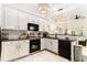 Modern kitchen featuring sleek appliances, stylish lighting fixtures, and a seamless transition to the living space at 1976 Cobblestone Ne Cir, Atlanta, GA 30319