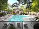 Community pool with many chairs and a charming building at 1976 Cobblestone Ne Cir, Atlanta, GA 30319