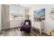 Comfortable sitting room featuring a tufted chaise lounge, accent furniture, and an abundance of natural light at 1976 Cobblestone Ne Cir, Atlanta, GA 30319