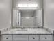Bathroom with stone counter vanity and a well-lit mirror reflecting the bathtub at 2901 Ne Lenox Rd # 305, Atlanta, GA 30324